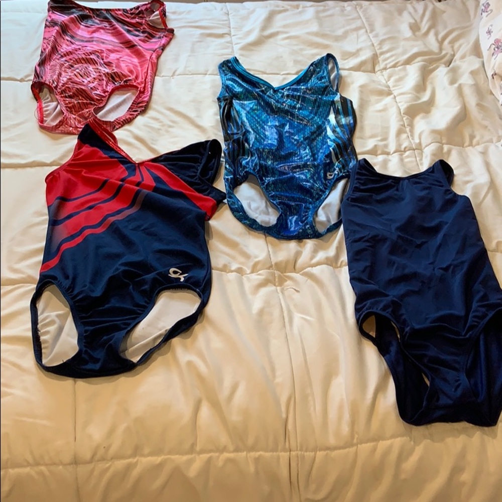 Four different color and style gymnastics leotards